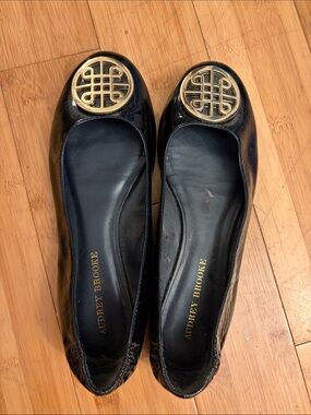 Audrey Brooke Black Patent Flats with Gold Medallion Accent